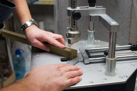 Craftsman working on frame in frameshop. Stock Photos