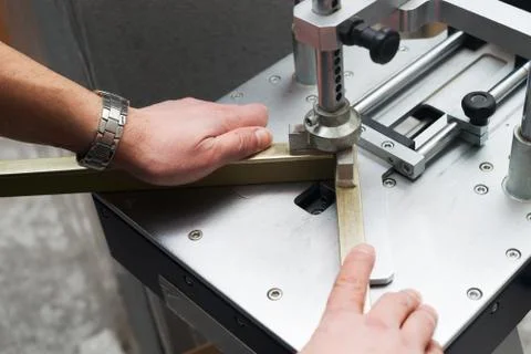 Craftsman working on frame in frameshop. Stock Photos