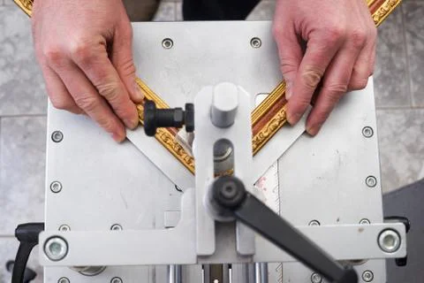Craftsman working on frame in frameshop. Stock Photos