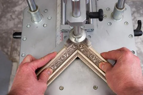 Craftsman working on frame in frameshop. Stock Photos