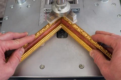 Craftsman working on frame in frameshop. Stock Photos