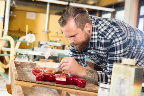 Craftsman working at workshop with a guitar Stock Photos