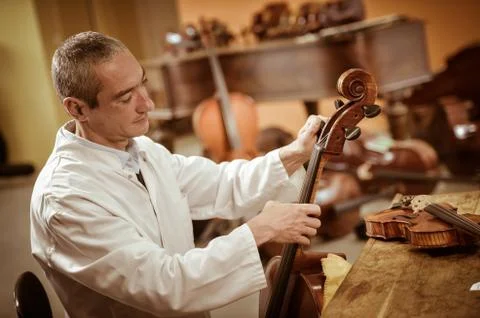 Craftsman working in workshop lutemaker Stock Photos