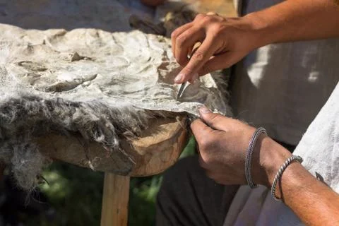 The craftsman works with the skin of an animal Stock Photos