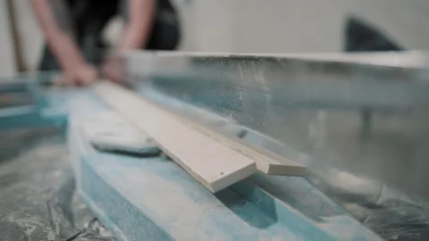 Craftsmanship as a man tiles a surface with precision and care in a bright Stock Footage 307040076