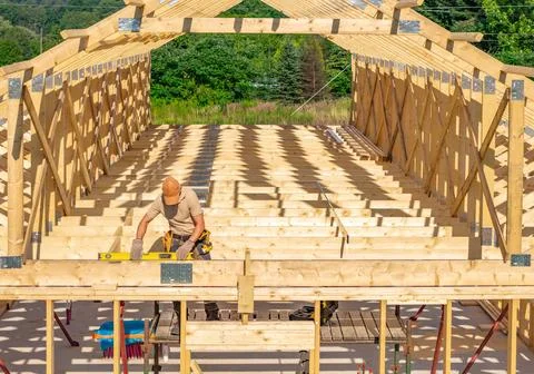 Craftsmanship Shines as Builder Constructs Wooden Framework in Sunny Outdoo.. Stock Photos