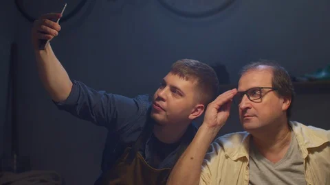 Craftsmen have fun in front of the phone camera Stock Footage 127834747