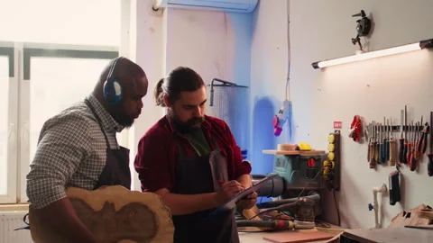 Craftsperson and woodworker looking over technical schematics Stock Footage 271156485