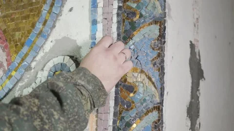 Craftsperson controls quality of grey piece of mosaic Stock Footage 146254744