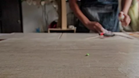 Craftswoman cleaning her worktable Stock Footage 232032999