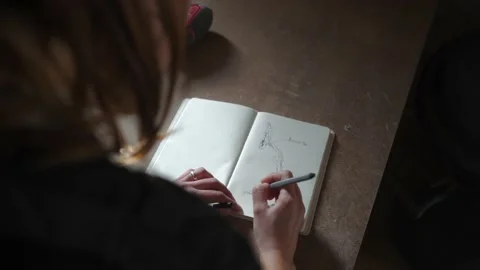Craftswoman drawing sketch in notebook Stock Footage 167422873