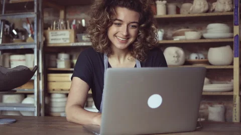 Craftswoman using laptop in art studio Stock Footage 161786958