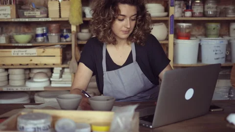 Craftswoman using laptop in art studio Stock Footage 161795808