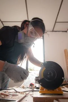 Craftswoman using a yellow machine 02 Stock Photos