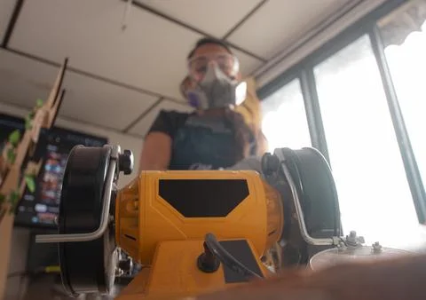 Craftswoman using a yellow machine Stock Photos