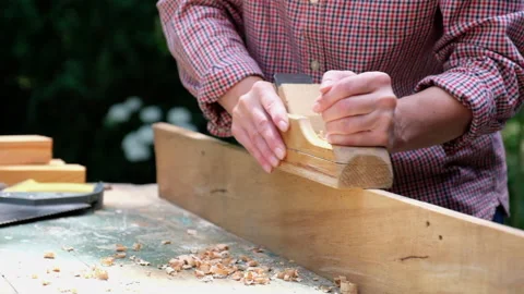 Craftswoman working with carpentry plane outdoors. Stock Footage 136035959