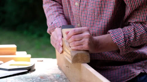 Craftswoman working in her workshop using carpentry plane Stock Footage 136035937