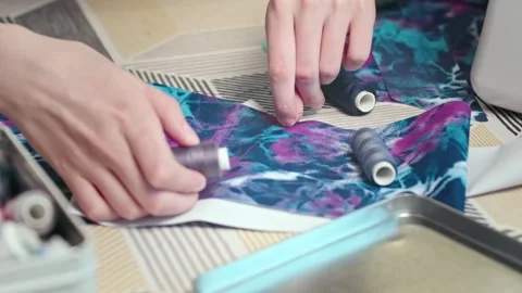 Craftswoman in the workshop selects threads for fabric Stock Footage 269807766
