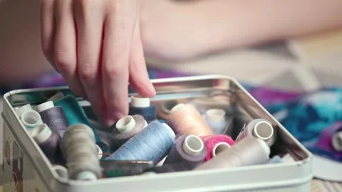 Craftswoman in the workshop selects threads for fabric 스톡 동영상 269807949