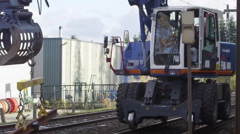 Crain machine lifting a piece of railroad track Stockbeeldmateriaal 52317857