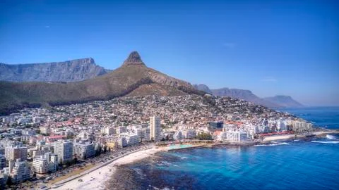 A crain view of Sea point with Table Mountain, Lions Head and blue sea. Stock Photos