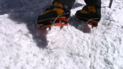 Crampons digging into snow as climber ascends Stock Footage 22226527