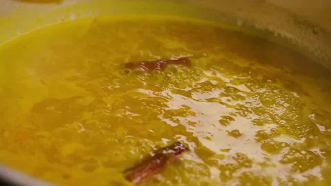 Cranberries are poured into a boiling base of orange juice, honey and cinnamon Stock Footage 312468772