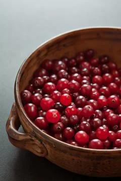 Cranberries in dark dish Stock Photos