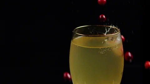 Cranberries Fall Into Cold Cocktail on Black Background Stock-Footage 120358598