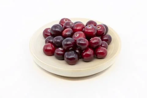 Cranberries on a plate isolate on a white background Stock Photos