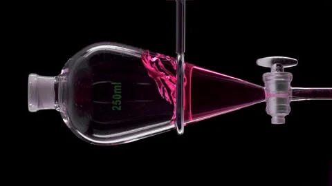 Cranberry extract injected in funnel producing liquid splashes Stock Footage 337761618