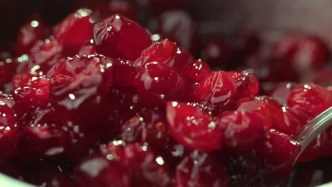 Cranberry jam is mixed with a spoon Stock Footage 121701782