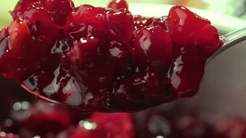 Cranberry jam is mixed with a spoon Stock Footage 121701786