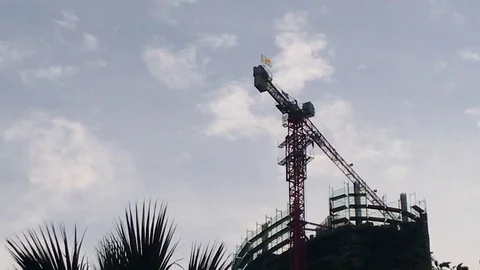 Crane Above a Skyscraper Construction Site Zoom in Time Lapse Shot Stock-Footage 101478648