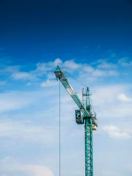 Crane against a blue sky. Stock Photos