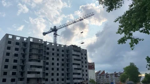 Crane and building construction site against cloudy sky. Stock Footage 310606345