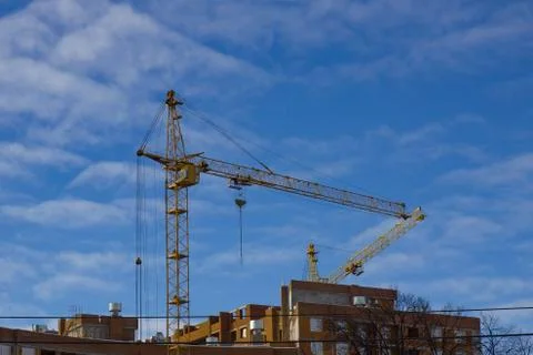 Crane and building construction site against blue sky Stock Photos