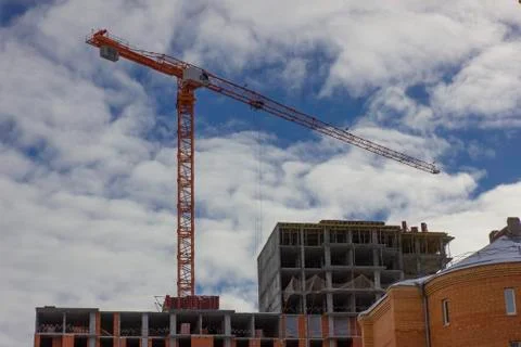 Crane and building construction site against blue sky. Stock Photos