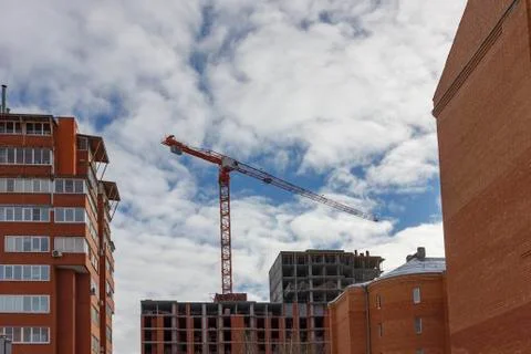 Crane and building construction site against blue sky. Stock Photos