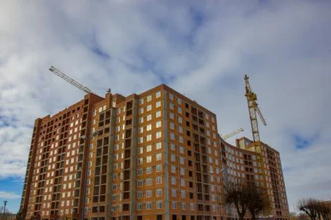 Crane and building construction site against blue sky Stock Photos