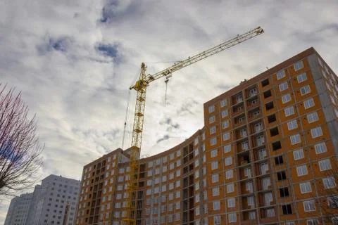 Crane and building construction site against blue sky Stock Photos