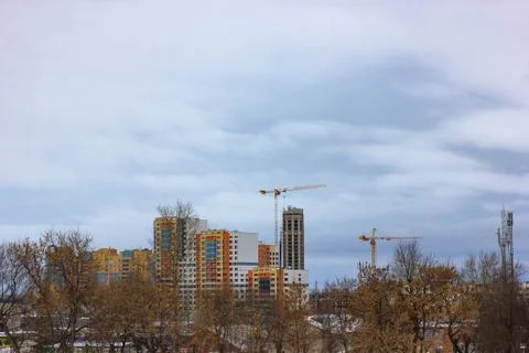 Crane and building construction site against blue sky Stock Photos