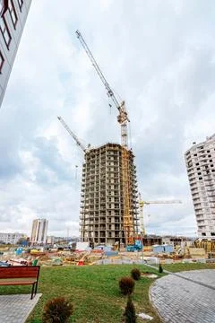 Crane and building under construction against blue sky Stock Photos