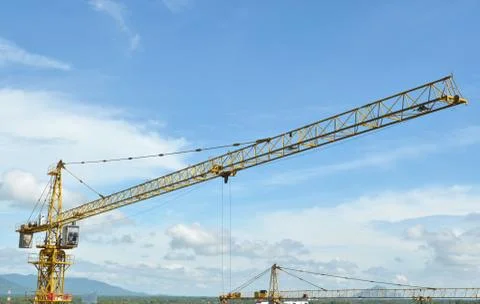 Crane and building working progress, construction site Stock Photos