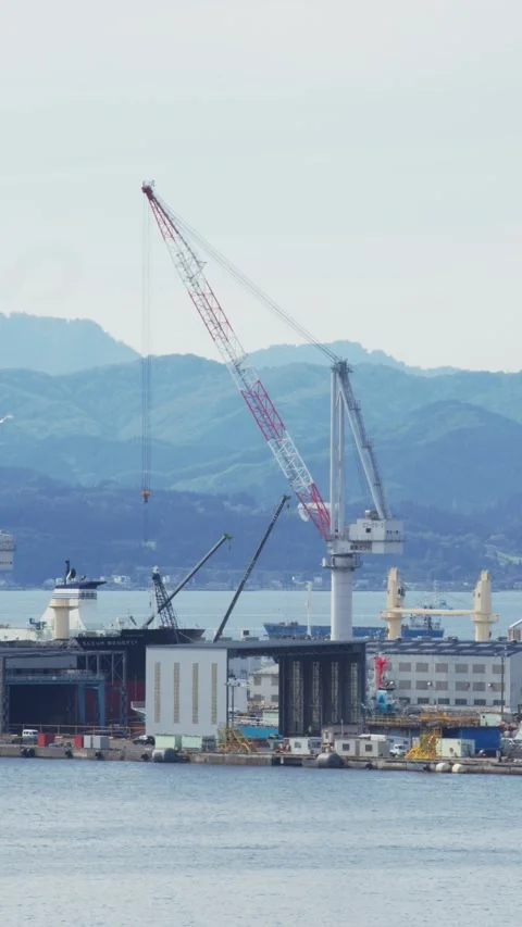Crane and shipyard facility over blue water, Hakodate, Japan, 2026.09.10. 動画素材 345440823