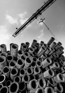 Crane and stack of pipes Stock Photos