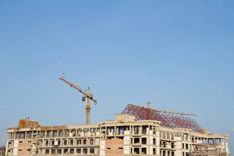 Crane and workers at construction Stock Photos