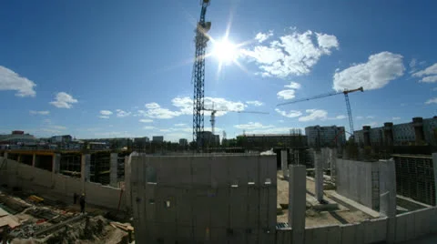 Crane and workers at construction site against blue sky. Stock Footage 25239545