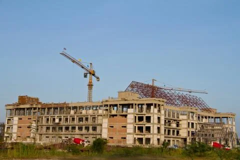Crane and workers at construction site against blue sky. thailand Stock Photos