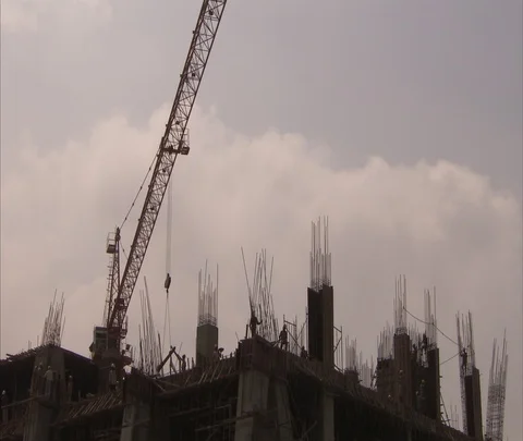 Crane and workers on scaffolding at construction site. Stock Footage 86741523